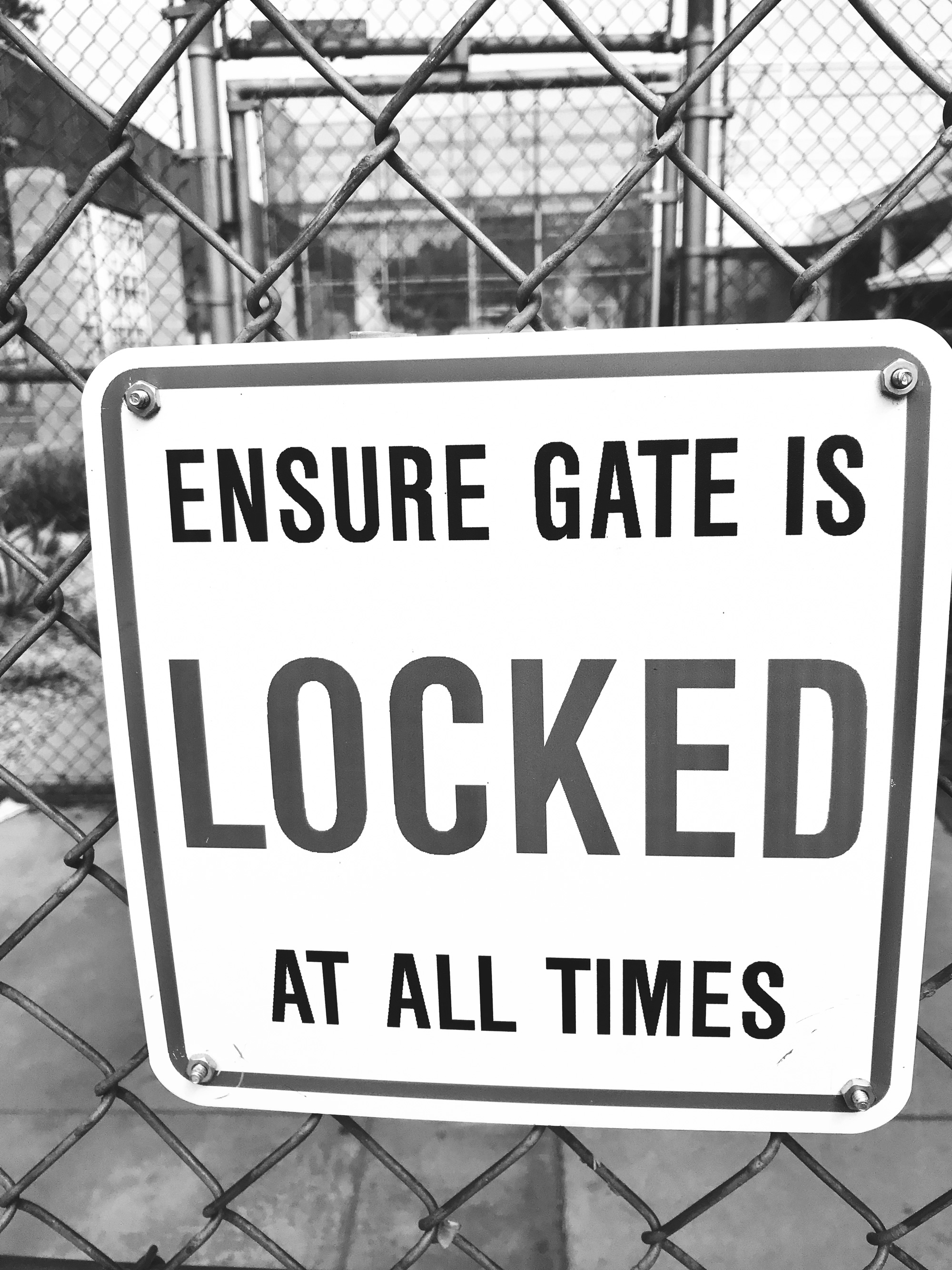 photo of a sign that reads: “Ensure gate is locked at all times.”